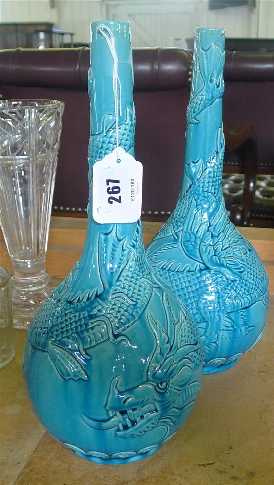 Pair of Burmantofts faience turquoise-glazed bottle vases, moulded with sinuous dragons (1 repaired rim)(-)